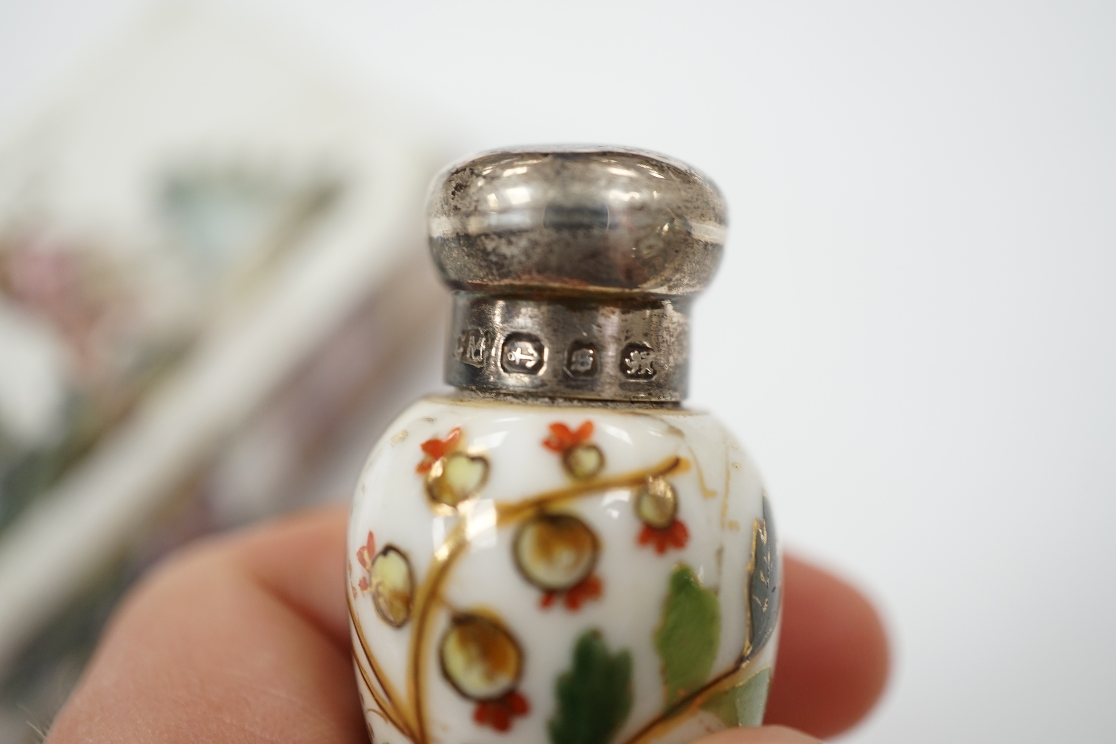An 18th century French enamel snuff box and a late 19th century silver mounted porcelain scent bottle, largest 7.5cm. Condition - box poor, scent bottle fair